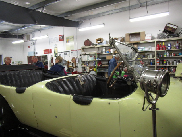 in the garage car working on